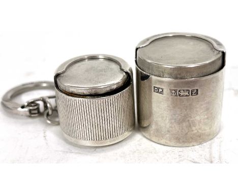 A hallmarked silver coin holder of drum shape, plain polished form, Birmingham 1985, makers mark for Douglas Pell Silverware,