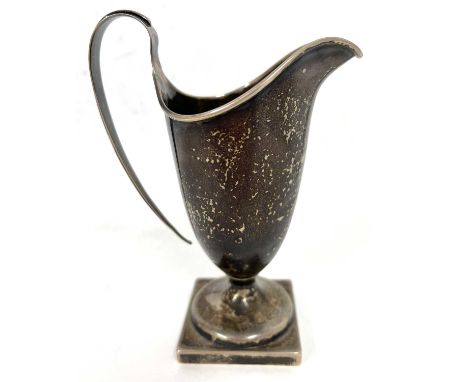 Hallmarked silver cream jug of helmet shape, the foot is a square pedestal form having a loop reeded handle design (a/f), 13c