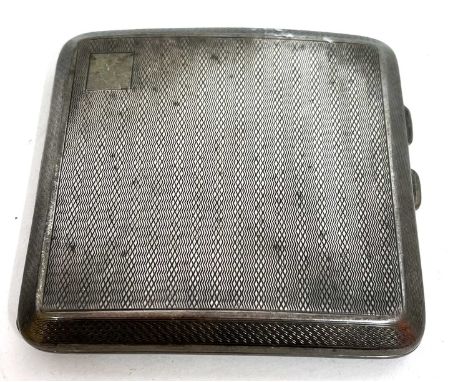 A George V silver cigarette case of slight curved square form, engine turned all over decoration with a vacant corner cartouc