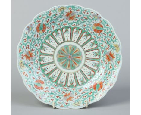 A 19th century Chinese Doucai lobed dish. Painted in underglaze blue and polychrome enamels with panels containing lotus scro