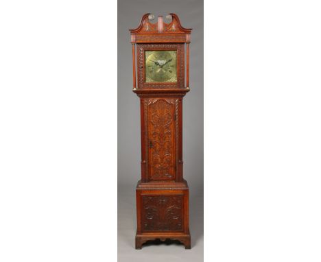 A George III oak longcase clock by John Lawson of Bradford. The heavily carved case with swan neck pediment, blind fret work,