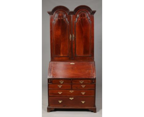 A George III Irish mahogany bureau bookcase. The top section with double dome top, strung panelled doors and fitted internal 