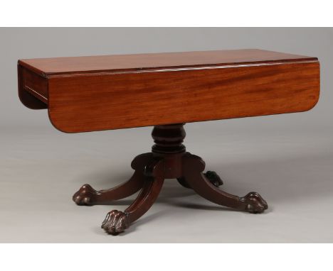 A William IV mahogany centre pedestal drop leaf breakfast table. With two concealed frieze drawers and raised on lion paw fee