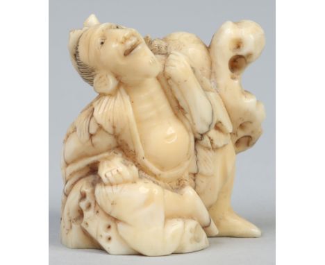 A Japanese Meiji period carved ivory netsuke formed as a nomad resting against a rock and carrying a gourd flask.    Conditio