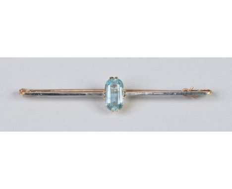 An Art Deco yellow metal bar brooch set with an ovoid faceted aquamarine, 6cm.   Condition Report. To be used as a guide only