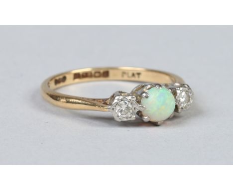 An 18 carat gold ring set with an opal flanked by a pair of diamonds. Size O.    Condition Report. To be used as a guide only