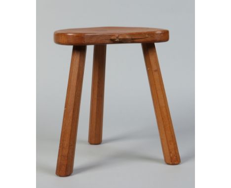 A Robert "Mouseman" Thompson oak three legged stool with dished kidney shaped top. Carved with the Mouseman motif to the fron