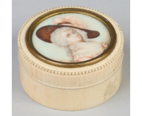 An early 20th century French circular ivory trinket box and cover set with a portrait miniature of a lady, 6.25cm diameter.  