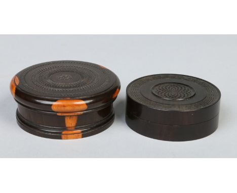 A 19th century Turned and carved coromandel snuff box with threaded cover and a similar ebony example. Largest 8cm diameter. 