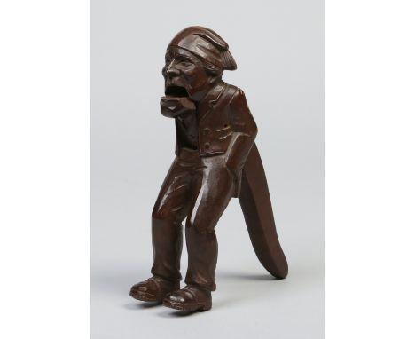 A Black Forrest carved walnut figural nut cracker, 20cm.   Condition Report. To be used as a guide only.  Good action. Some s