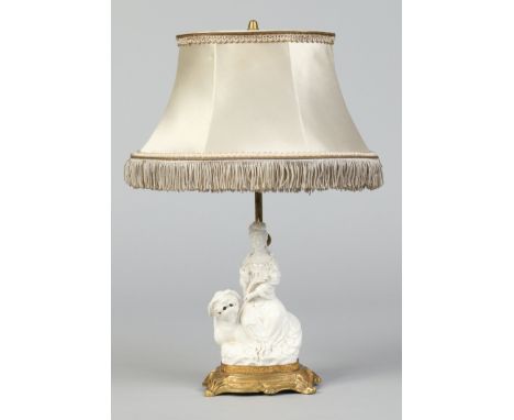 A French gilt metal rise and fall tablelamp with silk shade and mounted with a fine Chinese blanc de chine figure of Guanyin 