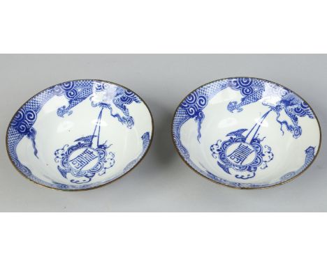 A pair of 20th century Chinese ogee shaped bowls with metal mounted rims. Decorated in underglaze blue with dragons and Buddh