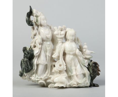 A Chinese carved white and green hardstone figure group. Depicting two female figures, one with a fly swish and ruyi sceptre 