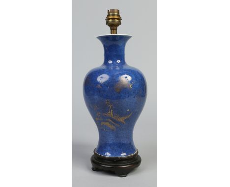 A Chinese baluster vase converted to a tablelamp and raised on a carved hardwood plinth. Powder blue ground and decorated in 