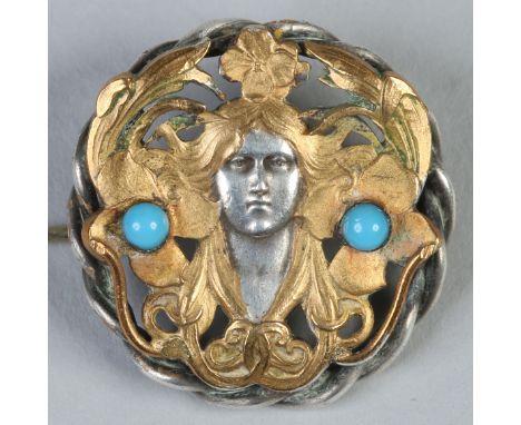 An Art Nouveau Continental white and gilt metal brooch. Set with turquoise and depicting the portrait of Sarah Burnhardt afte