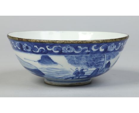 A Chinese bowl with metal mounted rim. Painted in underglaze blue with a river landscape. Character mark, 16.25m diameter.   