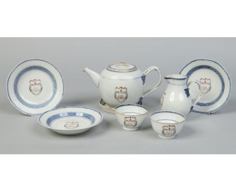 An 18th century Chinese export armorial part tea service. With ozier mould and under glaze trellis borders and having flower 