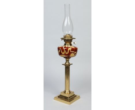 A Victorian oil lamp with Duplex burner, tortoiseshell glazed pottery font tube lined with leaves and hops and raised on a fl