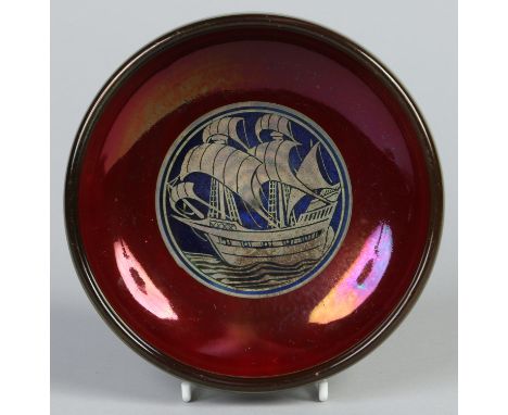 A Pilkingtons Lancastrian pottery bowl by William S. Mycock, 1924. With a ruby lustre ground and decorated with a stylized ga