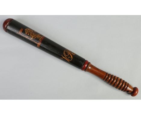 A Victorian turned hardwood truncheon. Black ground and painted with a crest of a lion holding a banner over a torse and with