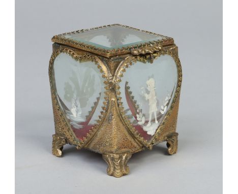 A brass and bevelled glass trinket box with bevelled heart shaped panels painted in the Mary Gregory style with white enamel,