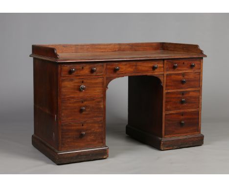 An early Victorian figured mahogany kneehole desk by Gillows of Lancaster. With full gallery over three frieze drawers, havin