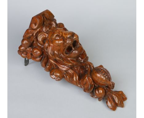 A Flemish carved oak corbel ornamented with a lion mask, fruit and foliage, 43cm.    Condition Report. To be used as a guide 