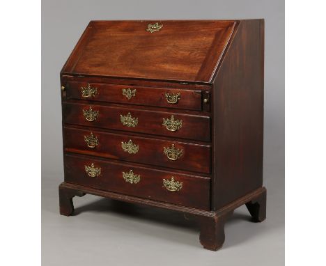 A George II mahogany bureau. With fitted interior, having four graduated drawers and raised on bracket feet, 103cm high, 91.5