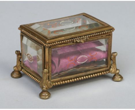 A brass trinket box of casket form, with bevelled glass sides having painted decoration and raised on scrolling feet, 10.5cm 