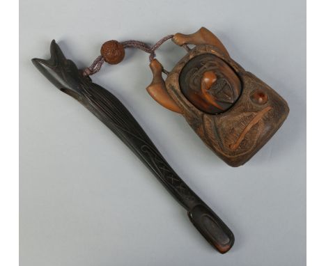 A Japanese carved bamboo tobacco box in the form of a nomad and a carved hardwood pipe adjoined with a lacquered ojime bead b