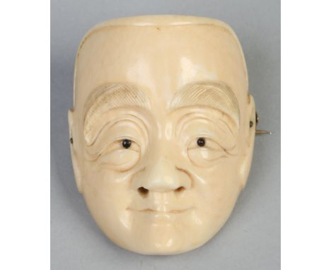 A Japanese Meiji period carved ivory netsuke converted into a brooch. Formed as a mask of concave form, 4.5cm.   Condition Re