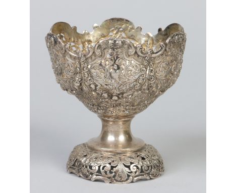 A 19th century white metal pedestal bowl. With C scroll moulded rim, pierced and embossed with festoons, roses and birds, 13.