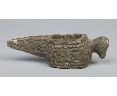 A carved granite oil lamp with birds head handle and bands of stylized decoration, probably medieval, 18.5cm.   Condition Rep