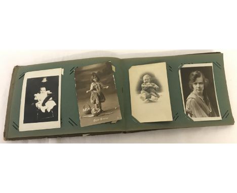 A vintage photograph album containing mainly Edwardian family portraits.  