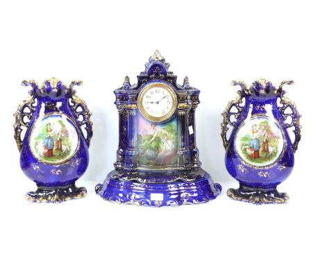 Porcelain mantel clock garniture architectural form two peasant women to front on a midnight blue ground with base, and pair 
