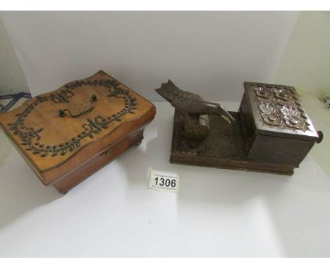 A small jewellery box with metal decoration and a novelty cigarette box.