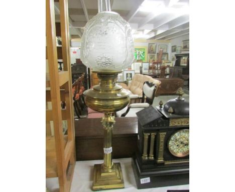 A brass Corinthian column oil lamp with etched glass shade.