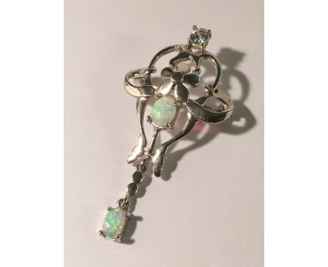 A gem set opal brooch/pendant in silver coloured metal.