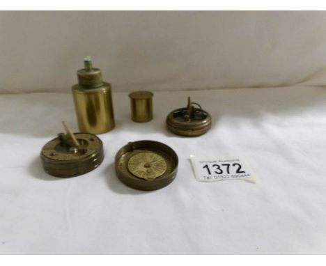 2 brass compass's and a brass wick lamp.