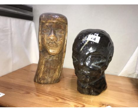 A head sculpture in brown ceramic and a native wooden bust.