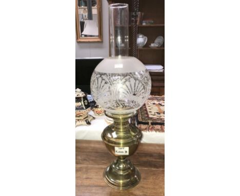 A brass oil lamp with globe & chimney