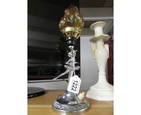 A chrome art deco figure lamp with amber glass flame shade.