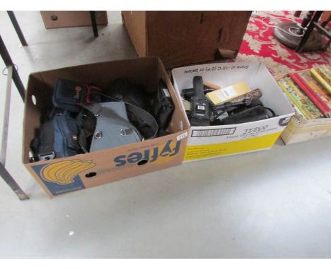 A box of camera cases and a box of camera accessories.