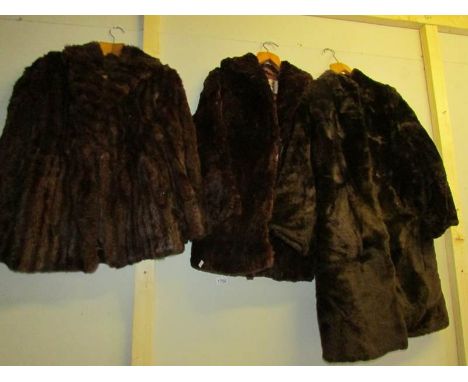 A fur coat and 2 fur jackets.