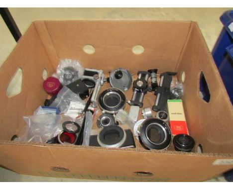 A box of vintage camera shutters, top quality enlarger lens etc.,