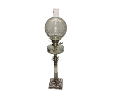 A silver plated Corinthian column oil lamp with glass font and etched shade.