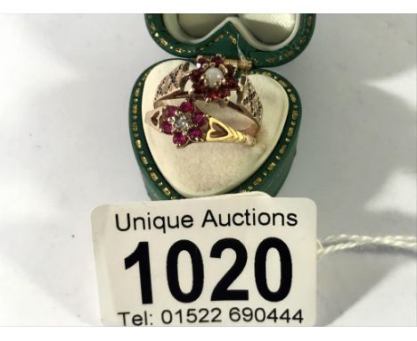 A ruby and diamond cluster ring in 9ct gold H.M Birmingham 1985 and a garnet cluster ring set in 9ct gold, sized J &amp; K,