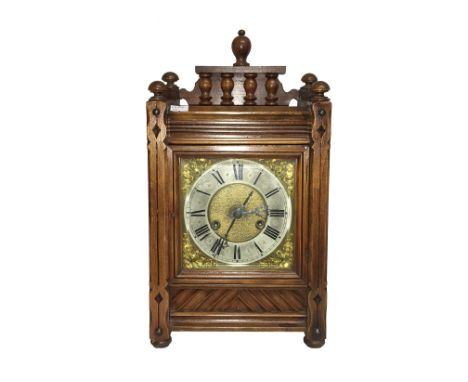 An oak cased mantel clock with 3 stars marked to mechanism.
