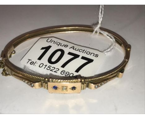 A Victorian diamond, sapphire and pearl bangle in 9ct gold, stamped.