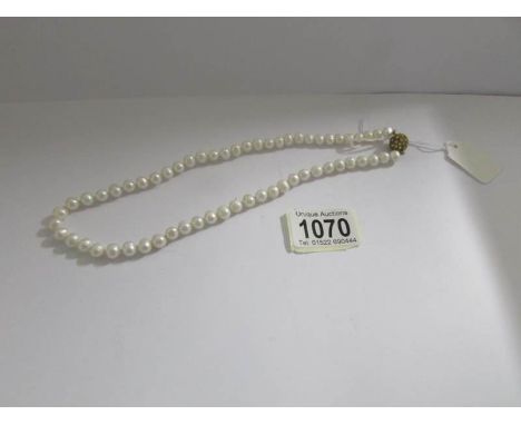 A cultured pearl necklace with stone set clasp.